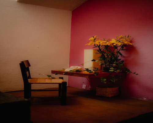 A well-illuminated reading corner in a Mexican home with warm lamp light